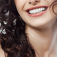 Woman smiling with impossibly perfect teeth